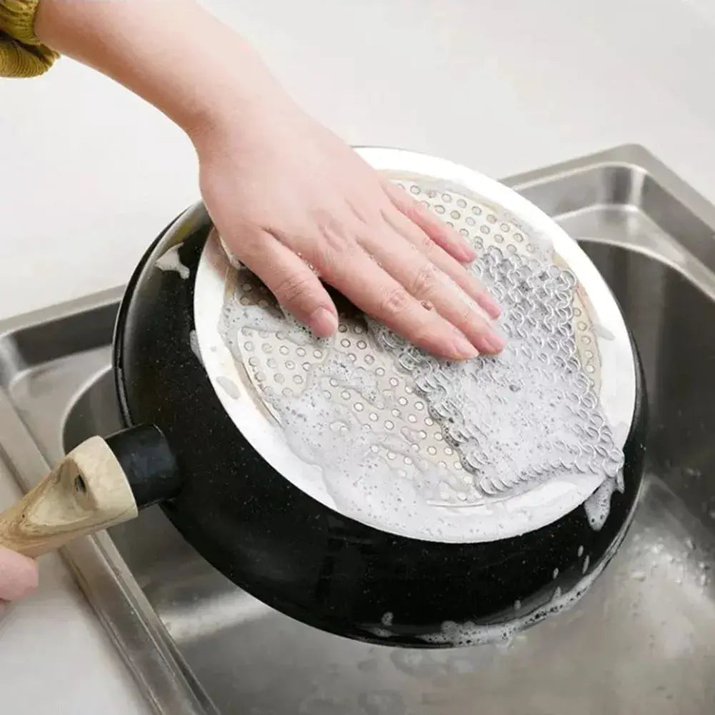 Stainless steel chain-mail scrubber for cast-iron pans, hand washing a pot in sink