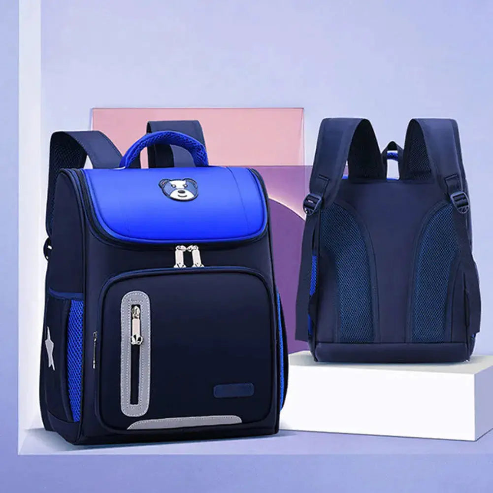 School backpacks by Simples Market: two navy blue kids' backpacks with reflective top, front zip pocket, and mesh side pockets