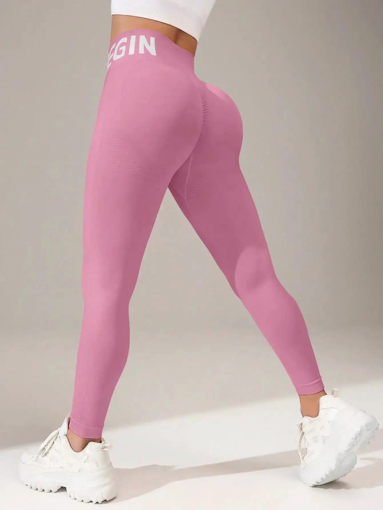 Pink seamless yoga leggings with a white waistband lettering, butt-lifting fit, quick-dry breathable tights