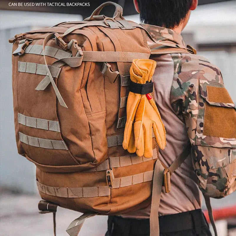 Multi-purpose nylon work gloves clipped to a tan tactical backpack with orange gloves attached for outdoor camping