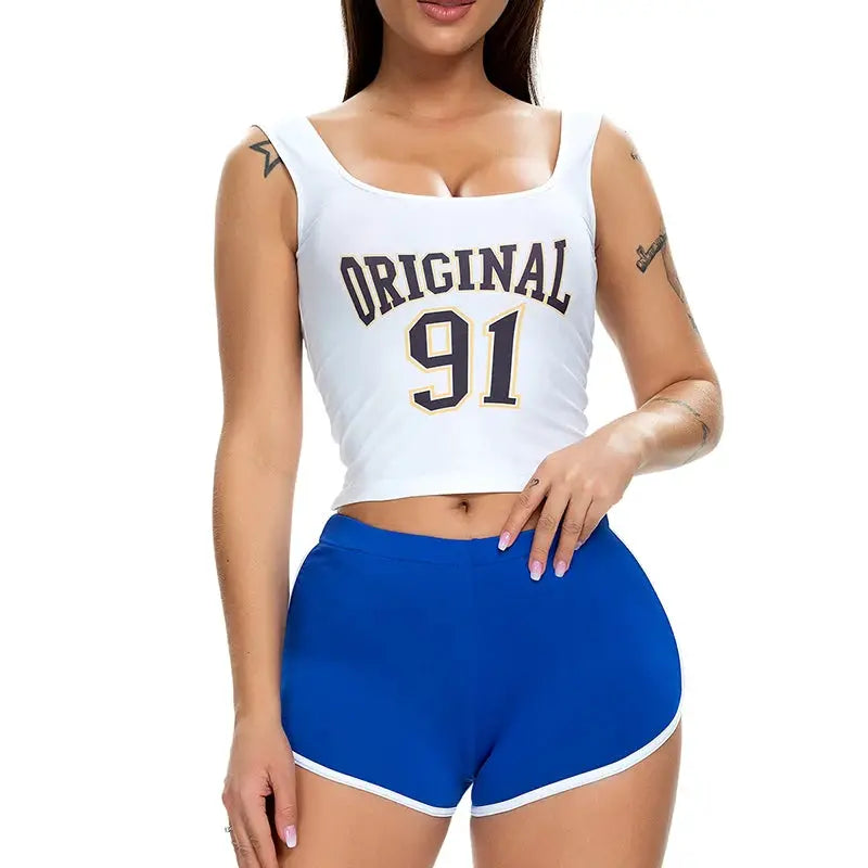 Women's blue athletic shorts with white trim paired with a white sleeveless crop top.