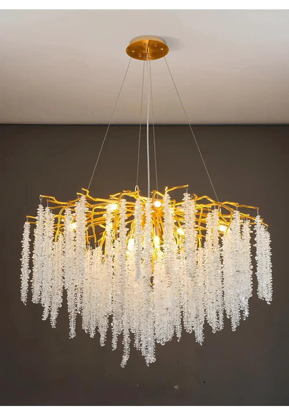 Modern crystal chandelier with gold-toned frame and long hanging crystal strands for living/dining room.