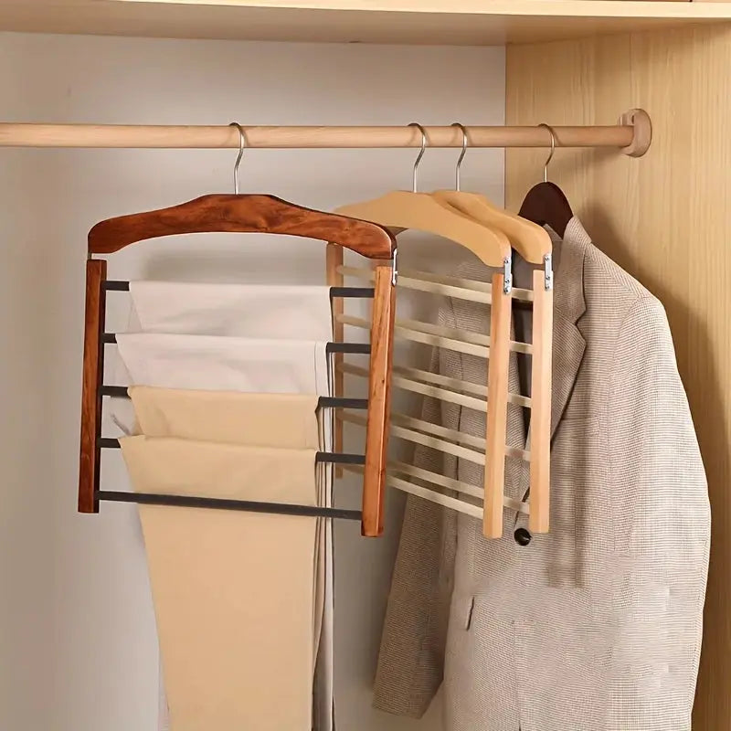 Solid wood multi-tier trouser rack in closet; three frames with horizontal bars for pants and shirts.