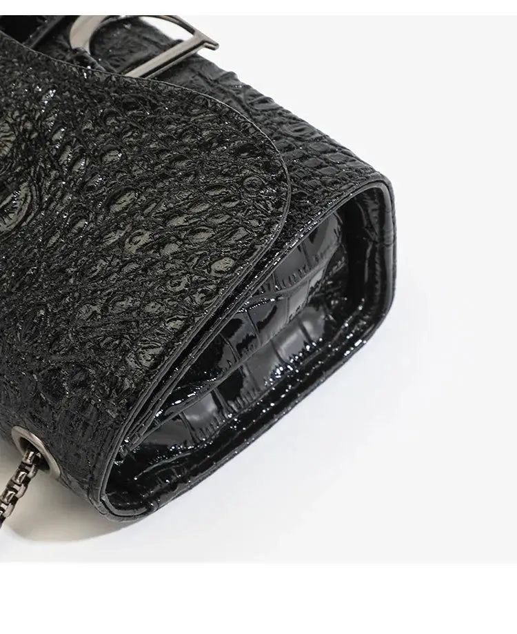 Women's luxury crossbody handbag, black sequined glossy finish with chain strap.