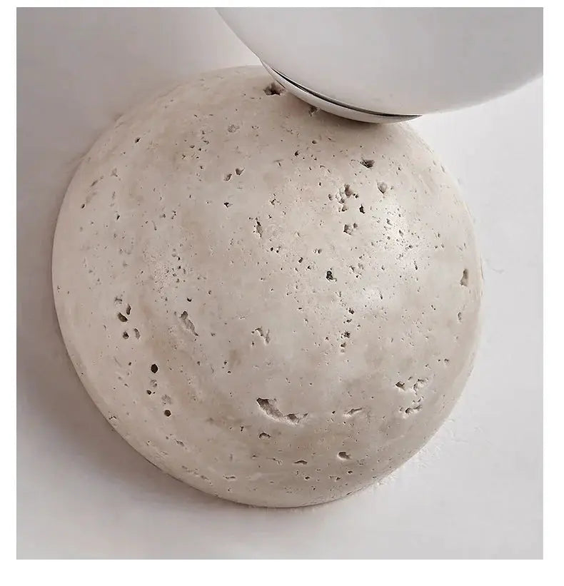 Cream-style LED wall lamp with cave-stone texture, round sphere base for bedroom or living room.