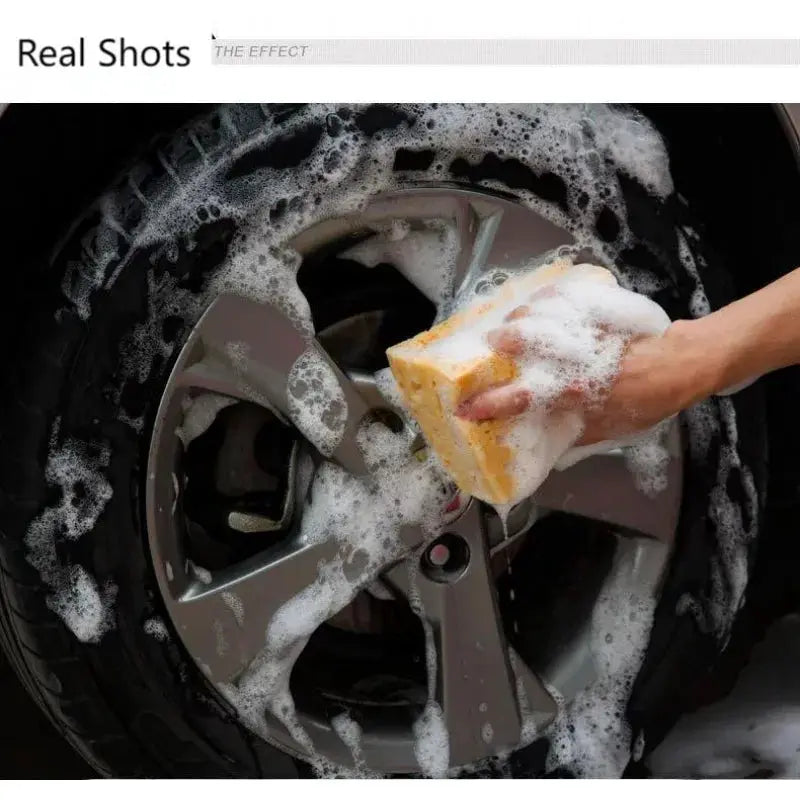Car wash sponge block by Simples Market; large yellow honeycomb sponge scrubs a car wheel.