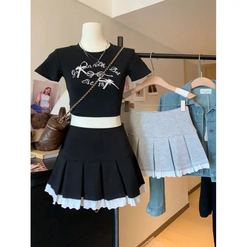 Flume edge lace skirt by Simples Market; black pleated A-line with white lace hem, gray version on hanger (2 skirts shown)