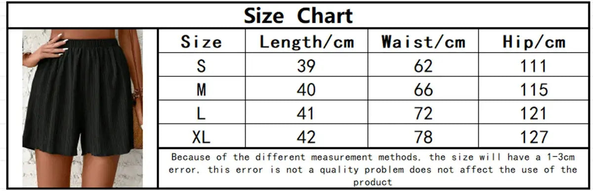 Women’s solid black elastic-waist shorts; model wearing them with a size chart beside.