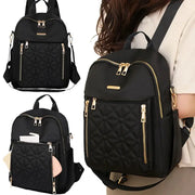 Backpack by Simples Market, black nylon with quilted front pocket and gold zippers.