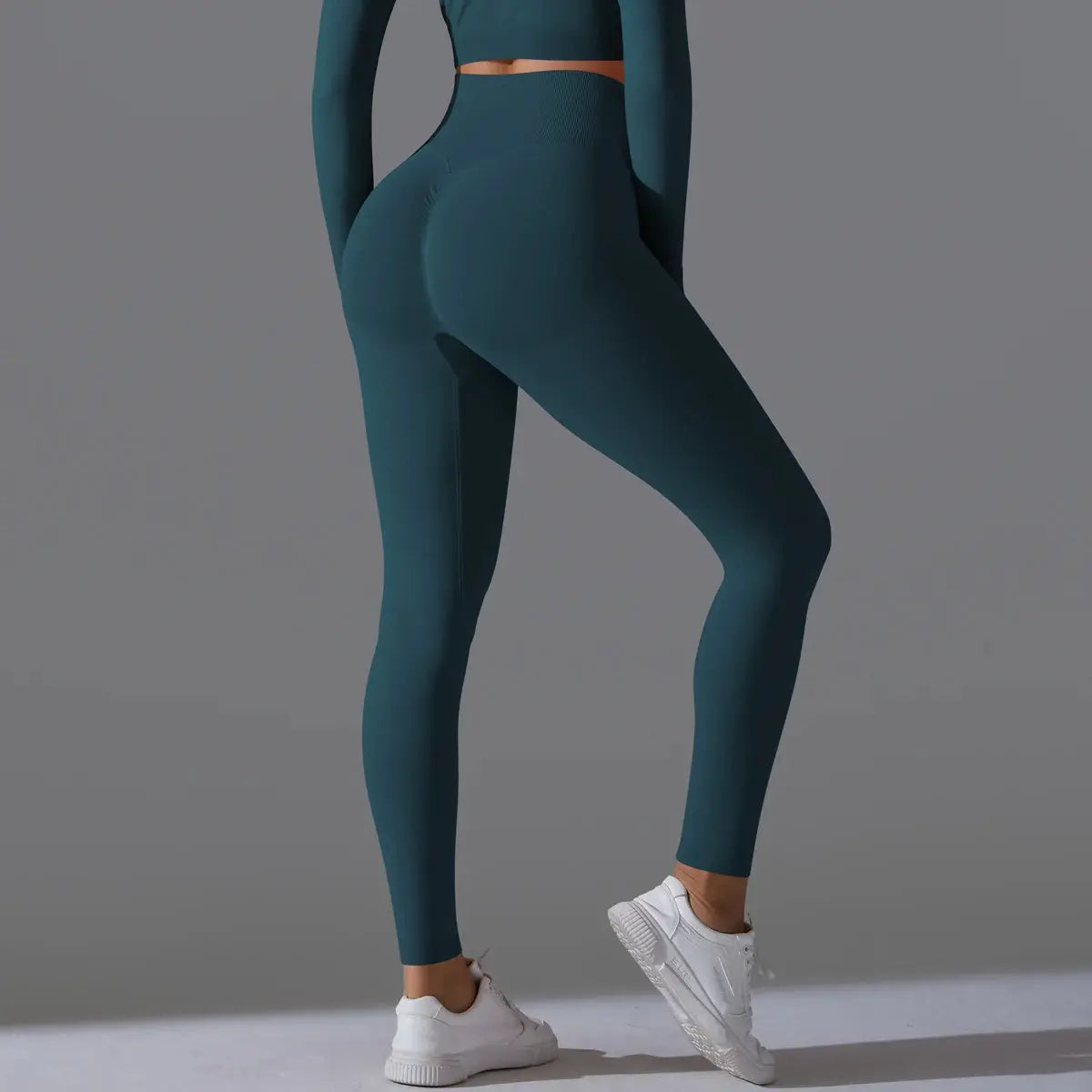 Women's seamless yoga leggings in teal with high-waist tummy control, scrunch butt for gym workouts.