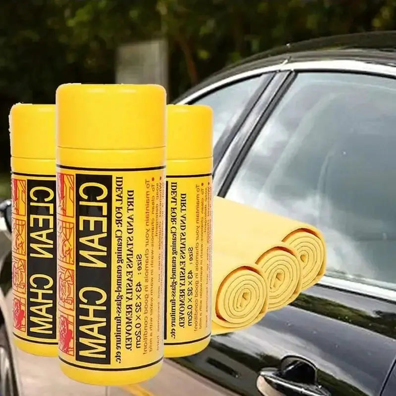 Car towel set with yellow towels and three yellow spray bottles beside a car