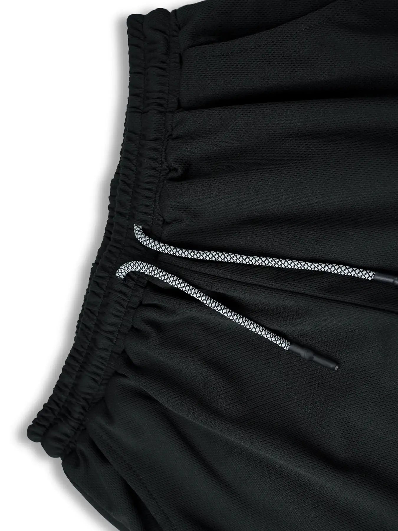 Men's black gym shorts with an elastic waistband and white drawstrings in mesh fabric.
