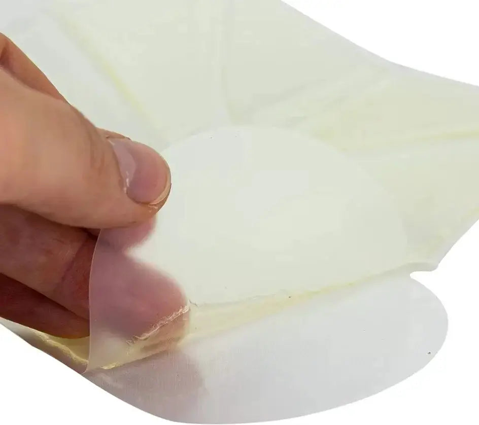 Chest Seal patch by Simples Market; round, sterile, transparent adhesive wound patch being peeled from backing.