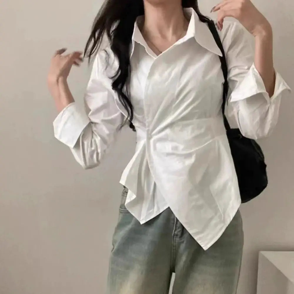 White wrap-front long-sleeve blouse with collar and asymmetric hem, office-ready.