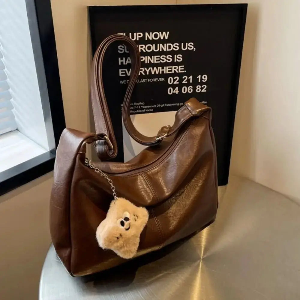 Brown PU leather slouchy shoulder bag with teddy bear charm and large capacity