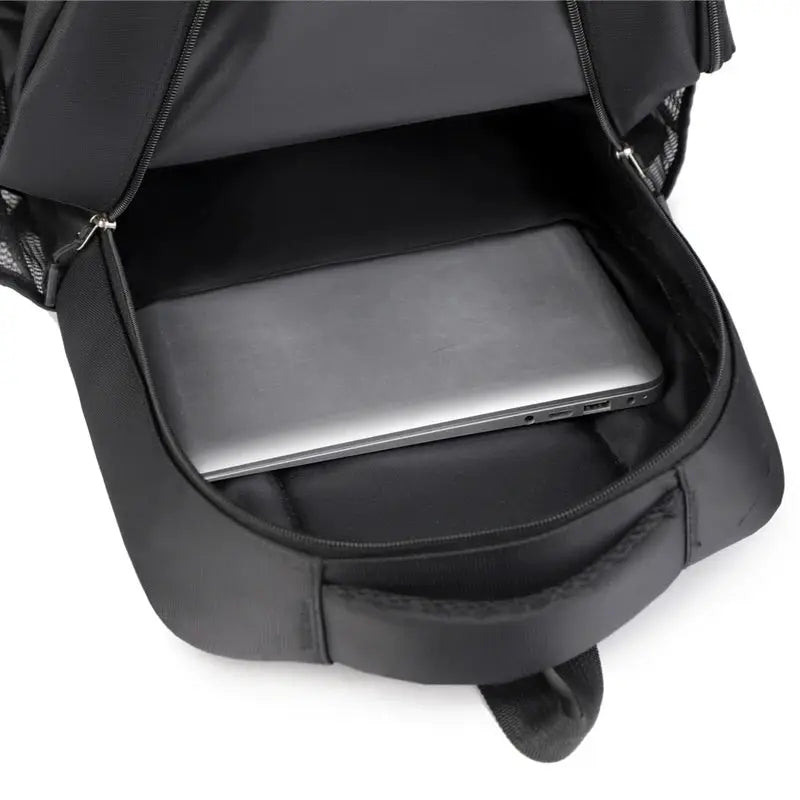 Simples Market travel backpack with large capacity; black fabric and front laptop compartment holds a silver laptop