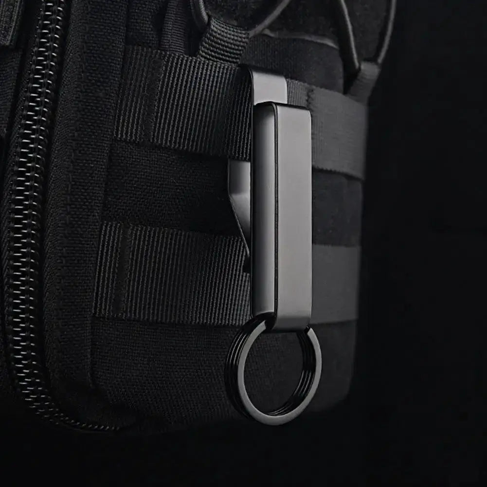 Stainless steel key clip with MOLLE waist hook and metal ring on black tactical bag by Simples Market