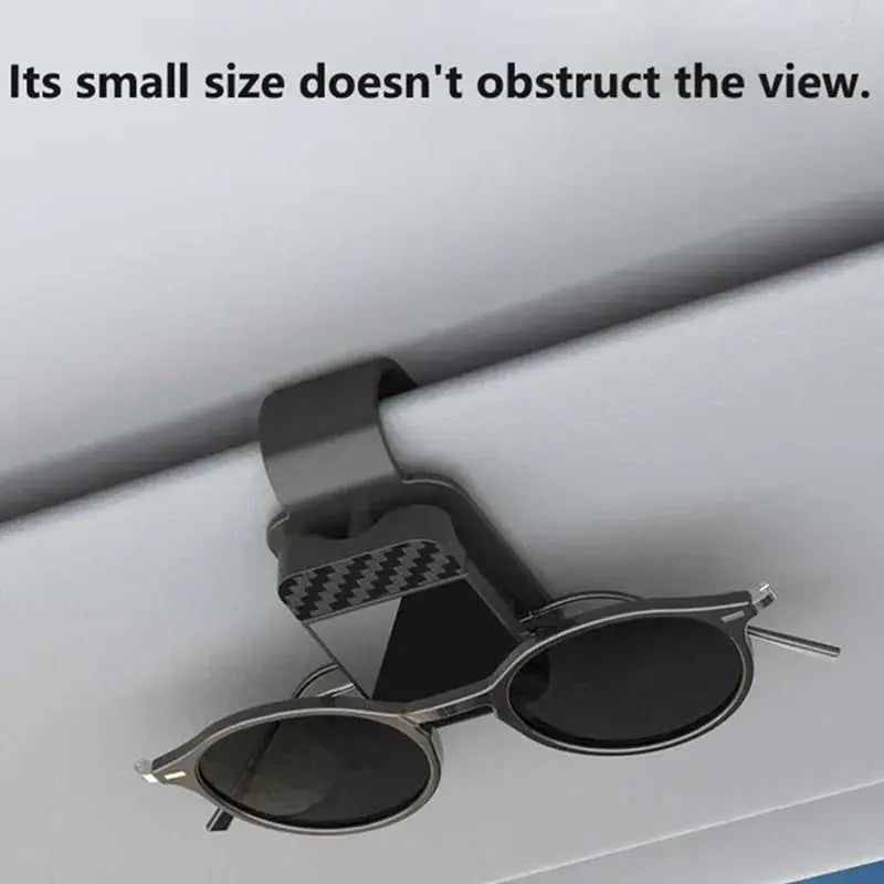 Car sun visor clip for sunglasses with card holder and storage; gray strap and black-framed glasses.