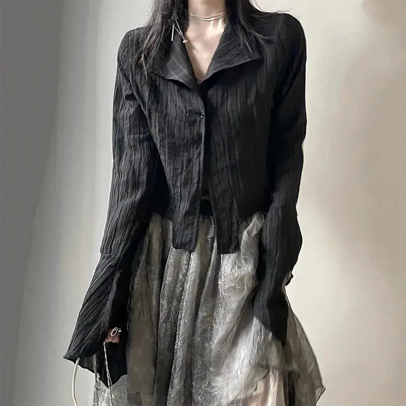 Gothic black blouse with crinkled texture paired with metallic-gray skirt; two-piece outfit