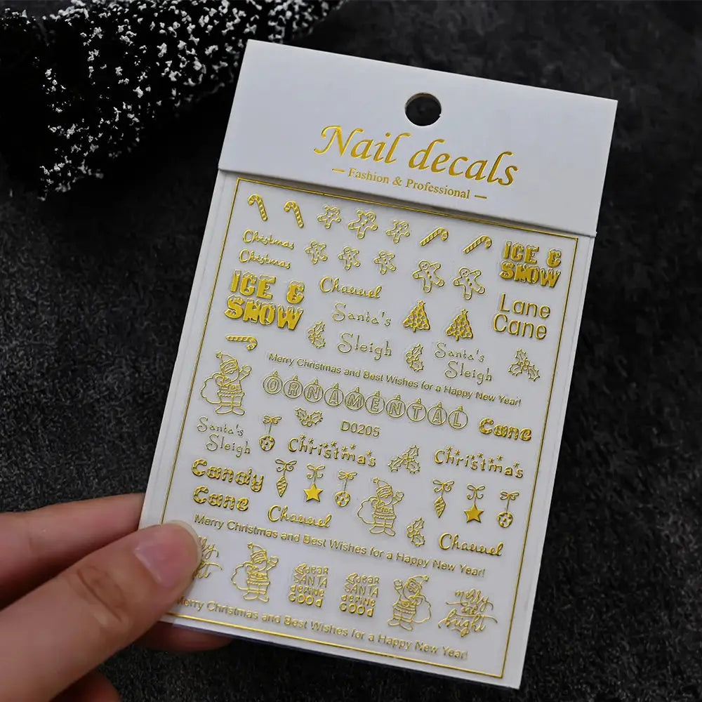 Gold nail decals sheet with Christmas motifs like snowman, candy cane and snowflakes by Simples Market