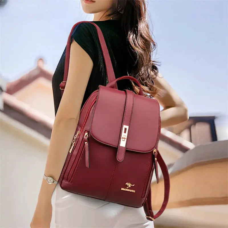 Leather backpack for women Simples Market burgundy with gold hardware and top flap closure.