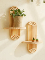 Wooden wall shelves in Boho style with geometric design, natural finish, wall-mounted, holding a potted plant