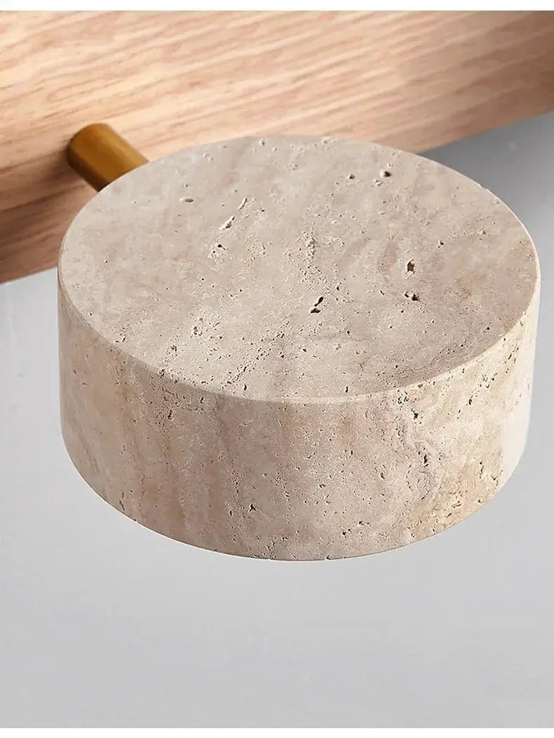 Round LED wall light with beige stone texture and wooden mounting peg.