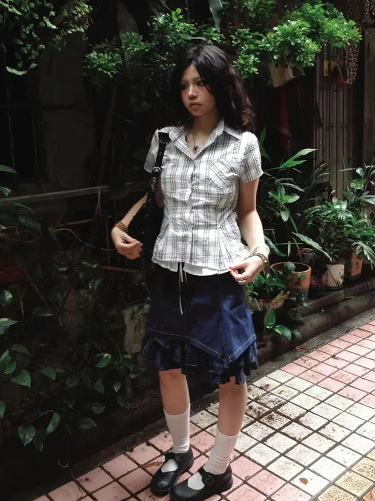Genayooa Y2k plaid short-sleeve blouse by Simples Market; light gray plaid with peplum, paired with navy layered skirt.