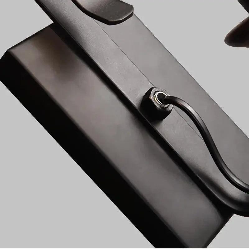 Wall lamp in black wrought-iron with a corded industrial design.