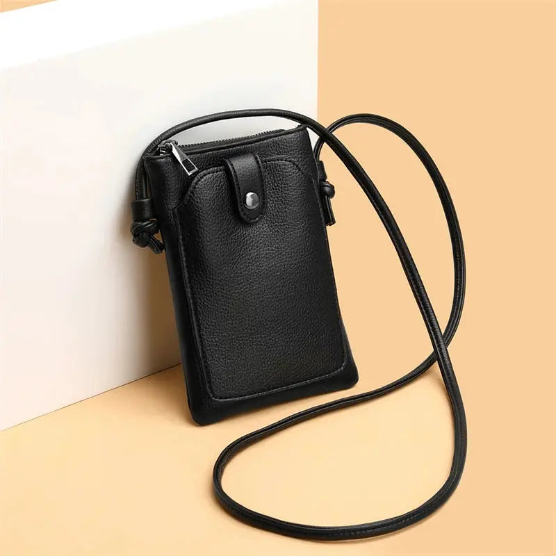 Black PU leather diagonal crossbody bag with long strap, compact mini phone-wallet style