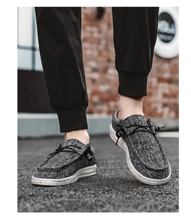 Pair of men's casual canvas loafers in heather gray with black laces and white soles