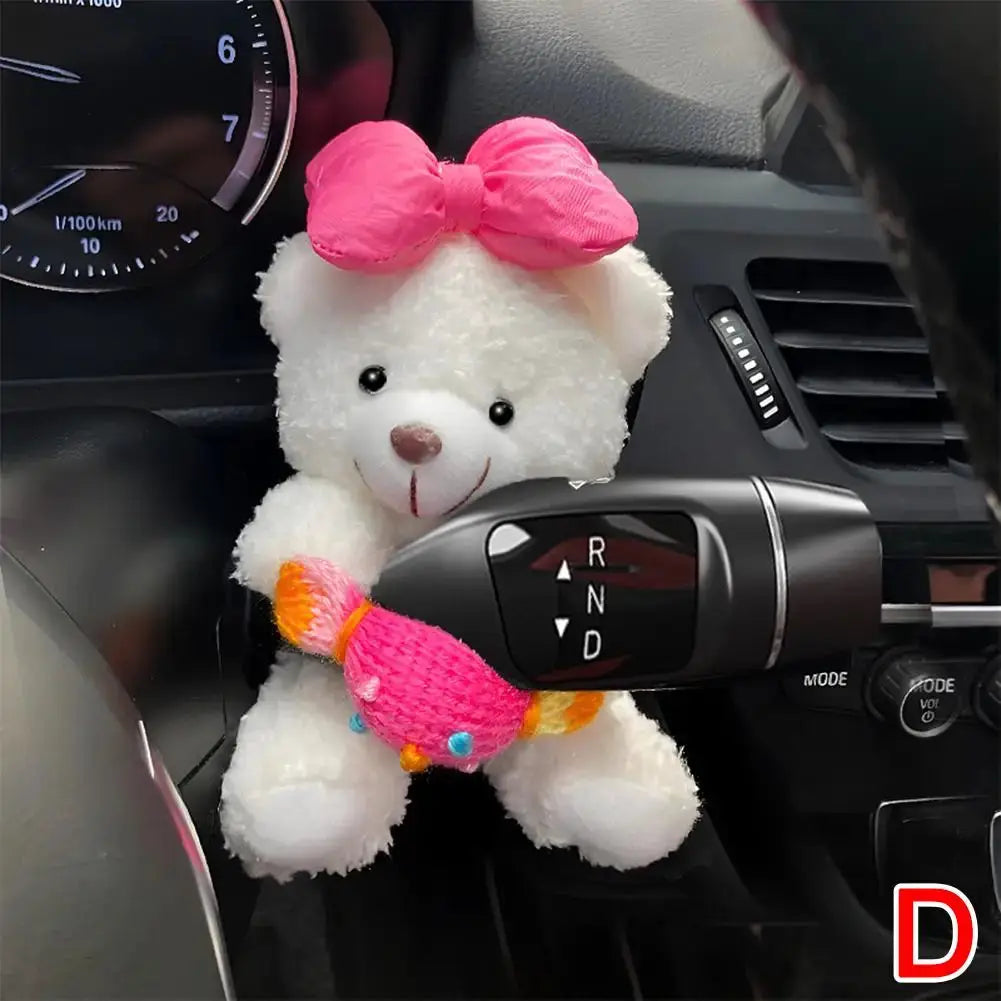 Pilot Bear plush car gear shift ornament; white teddy with bright pink bow, colorful scarf, attached near the gear lever