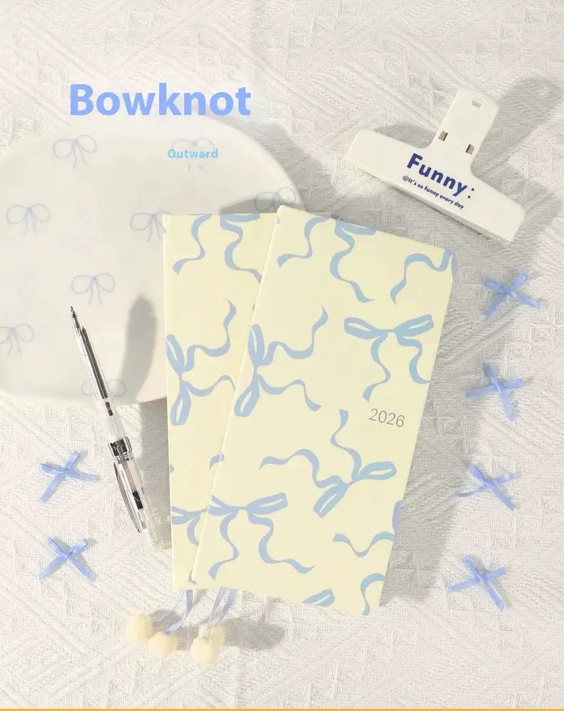 Kinbor 2026 weekly planner pocket-size notebook set, two cream notebooks with blue bow ribbon patterns