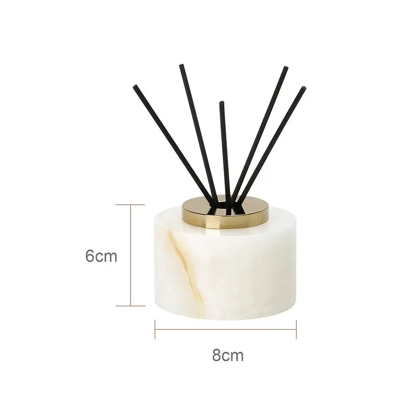 White onyx marble bathroom diffuser set by Simples Market with gold lid and black reed sticks