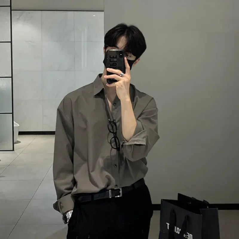 Men's gray long-sleeve shirt, solid color, with black belt and glasses hanging