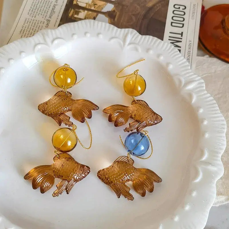 Pair of goldfish pendant earrings with translucent amber fish charms and yellow and blue beads