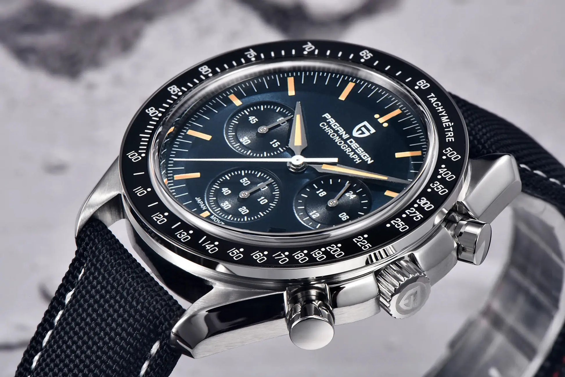Pagani Design chronograph watch with black dial, gold hands, tachymeter bezel, stainless steel case, fabric strap
