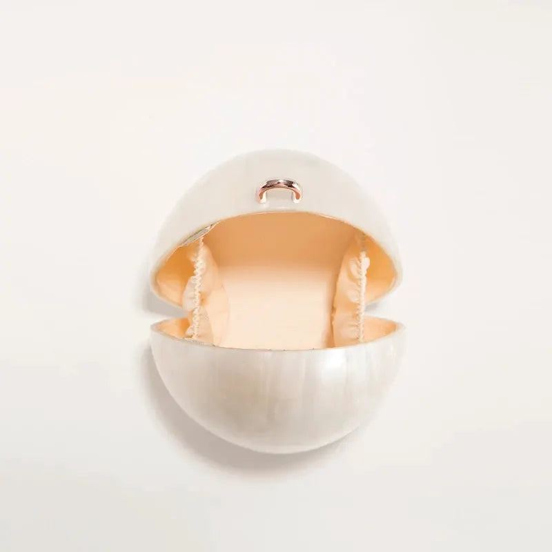 DONGSUO acrylic mini egg clutch in white with pearl finish and beaded strap