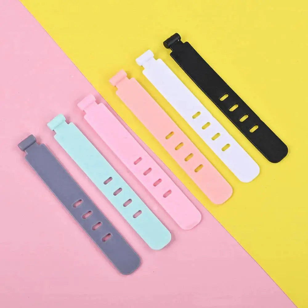 Silicone cable ties for cord management in pastel colors; reusable wire strap set of six.