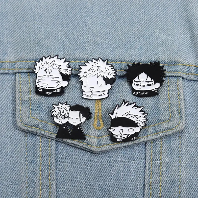Cartoon anime enamel pin set of 5 on denim jacket pocket; monochrome black-and-white character designs