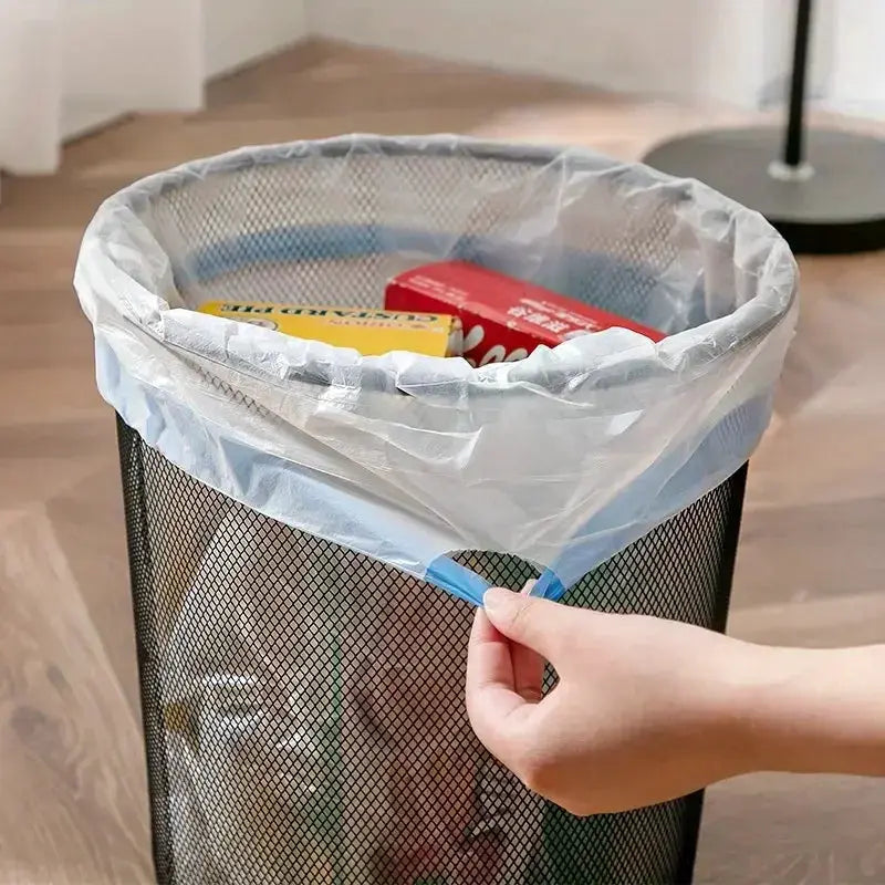 Drawstring garbage bag in a mesh trash can; large, thickened clear plastic with blue drawstring.