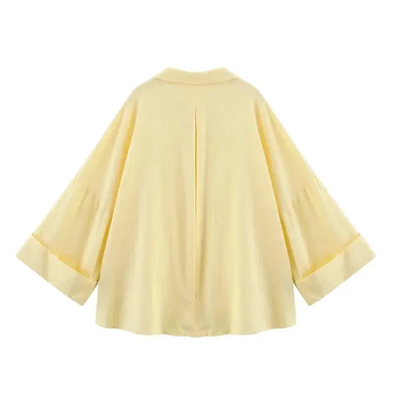 Yellow loose-fit women's blouse with wide kimono-style sleeves and a back pleat.