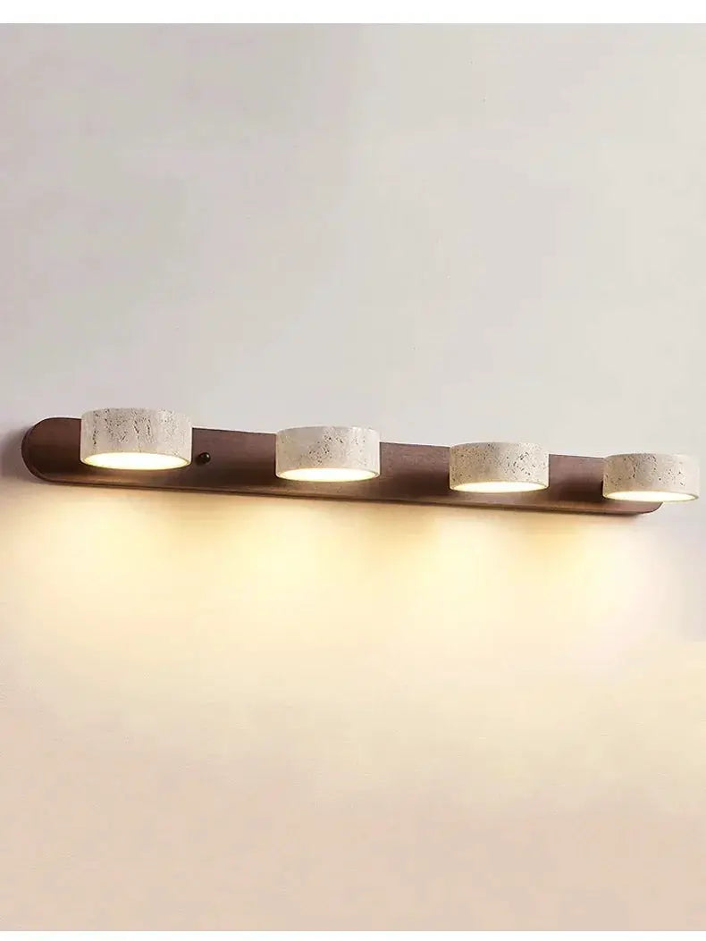 Four round LED wall lights on a wooden backplate with warm white illumination