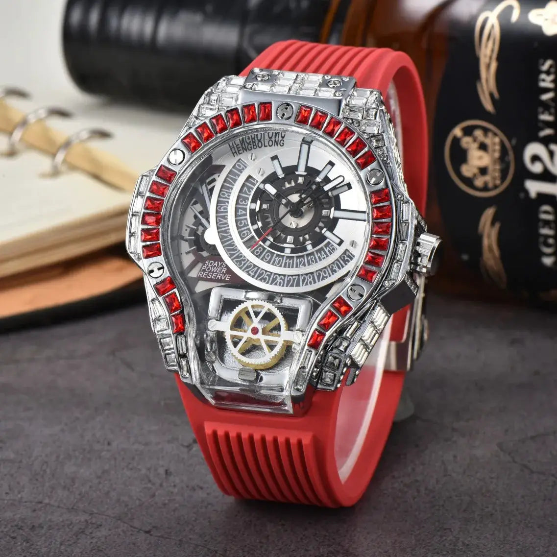 Men's luxury watch with red rubber strap and crystal-encrusted bezel, skeleton dial.