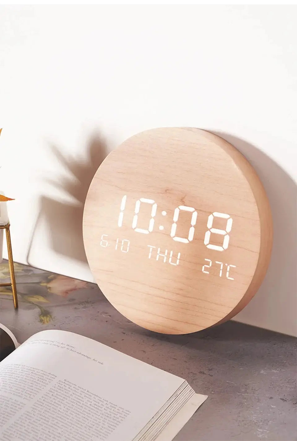 Round wooden LED digital wall clock with large white digits in a light wood finish, showing time, date and temperature.