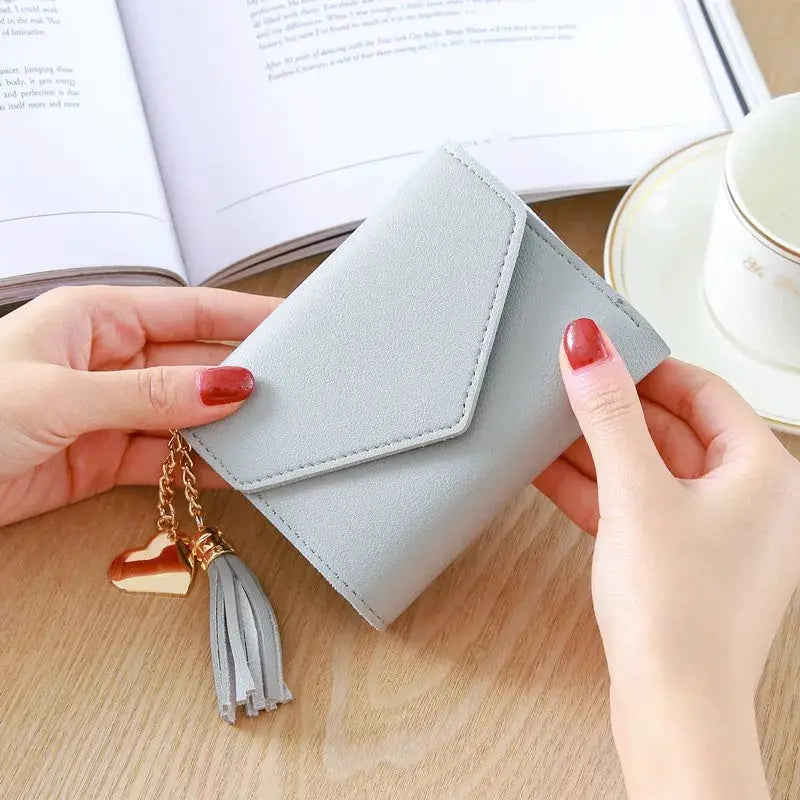 Compact light gray PU leather wallet with envelope-style flap and gold tassel charm