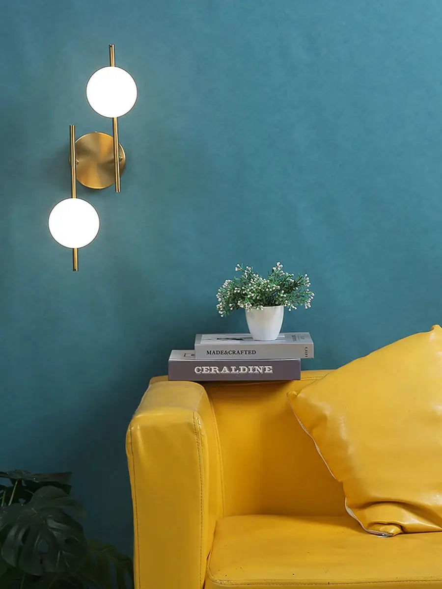 Simples Market modern LED wall lamp in golden metal with milky glass round bulbs, double G9 bulbs