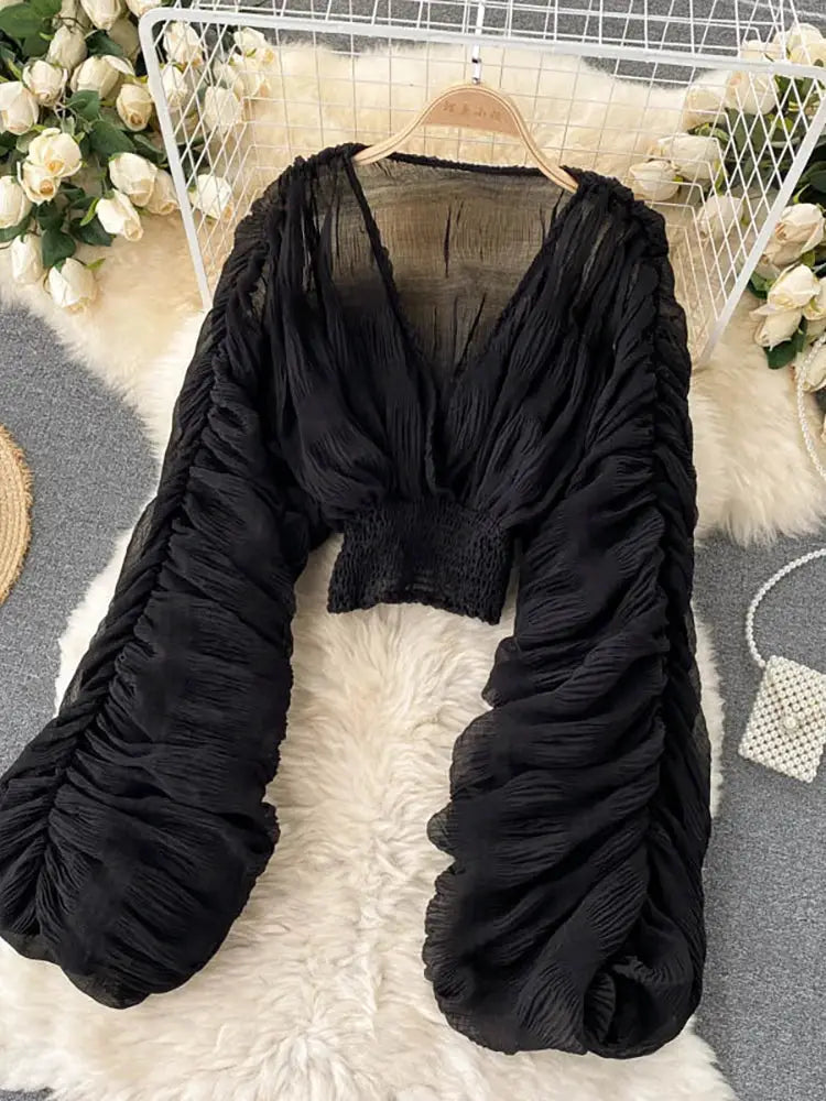 Black draped chiffon blouse with V-neck and puff sleeves from Simples Market, cropped smocked waist