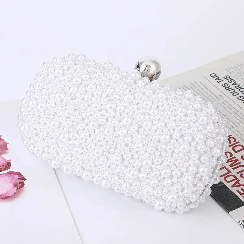 Pearl beaded evening clutch bag by Simples Market, white with a silver clasp.
