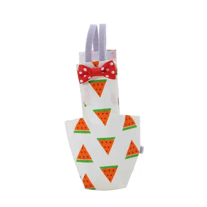 Parrot diaper with red bowtie, white fabric with orange watermelon-pattern triangles and purple straps.